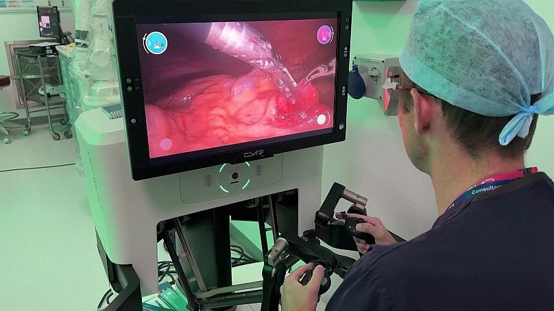 Ewan Brownlee, consultant en urologie pédiatrique à l'hôpital universitaire de Southampton, utilise des commandes à joystick pour effectuer l'opération