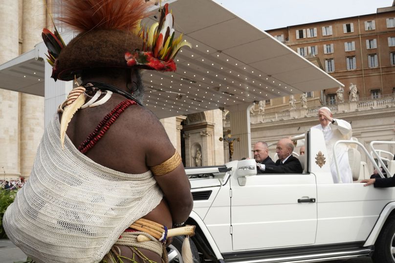 Le pape François salue le chef de la tribu Huli en Papouasie-Nouvelle-Guinée, Mundiya Kepanga, à son arrivée pour son audience générale hebdomadaire sur la place Saint-Pierre, au Vatican, mercredi