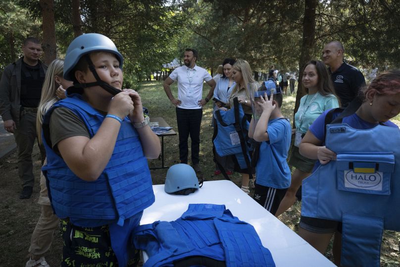 Les enfants portent des casques et des gilets lors de la formation à la sécurité dans les mines dans le camp de réhabilitation pour les enfants touchés par la guerre, organisé par la fondation caritative Voices of Children.