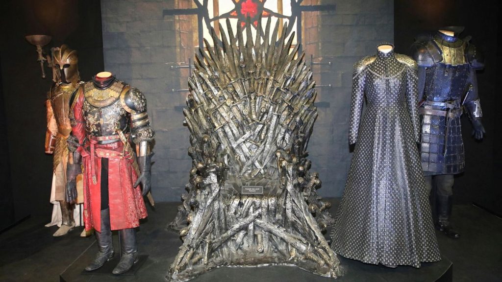 The Iron Throne and costumes on display during the launch of The Game of Thrones Touring Exhibition at the Titanic Exhibition centre in Belfast, Northern Ireland