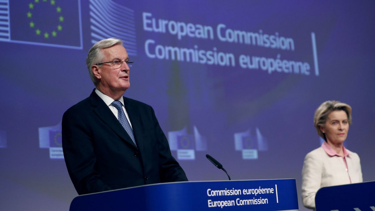 FILE - European Commission President Ursula von der Leyen, right, and Michel Barnier in Brussels, on Dec. 24, 2020.