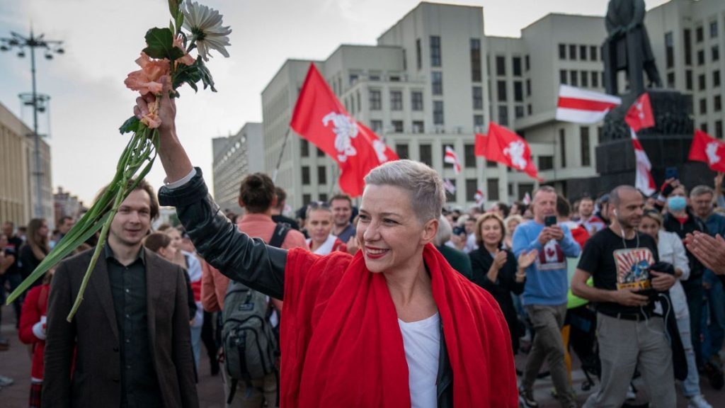 FILE – Opposition organiser Maria Kolesnikova greets protesters at a rally in front of a government building in Independent Square in Minsk, Belarus on Saturday, Aug. 22 2022.