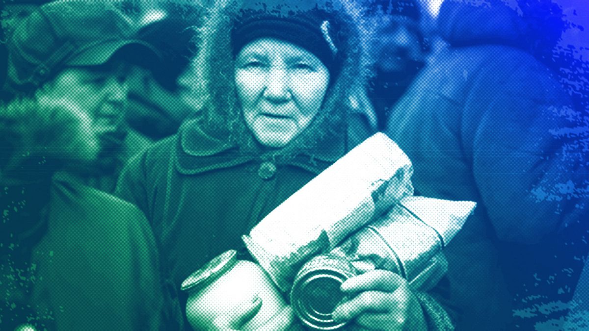 An elderly woman holds humanitarian aid distributed in Popasna, eastern Ukraine, October 2015