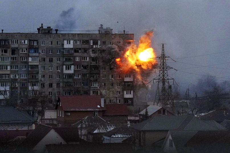 An explosion is seen in an apartment building after Russian's army tank fires in Mariupol, Ukraine, March 11, 2022.