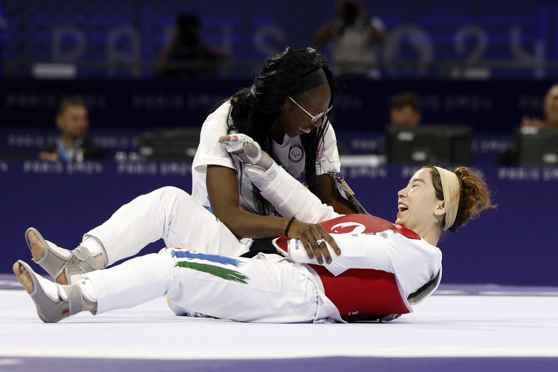 Zakia Khudadadi, de l'équipe paralympique des réfugiés, en bas, célèbre sa médaille de bronze en para-taekwondo lors des Jeux paralympiques de Paris, le jeudi 29 août 2024