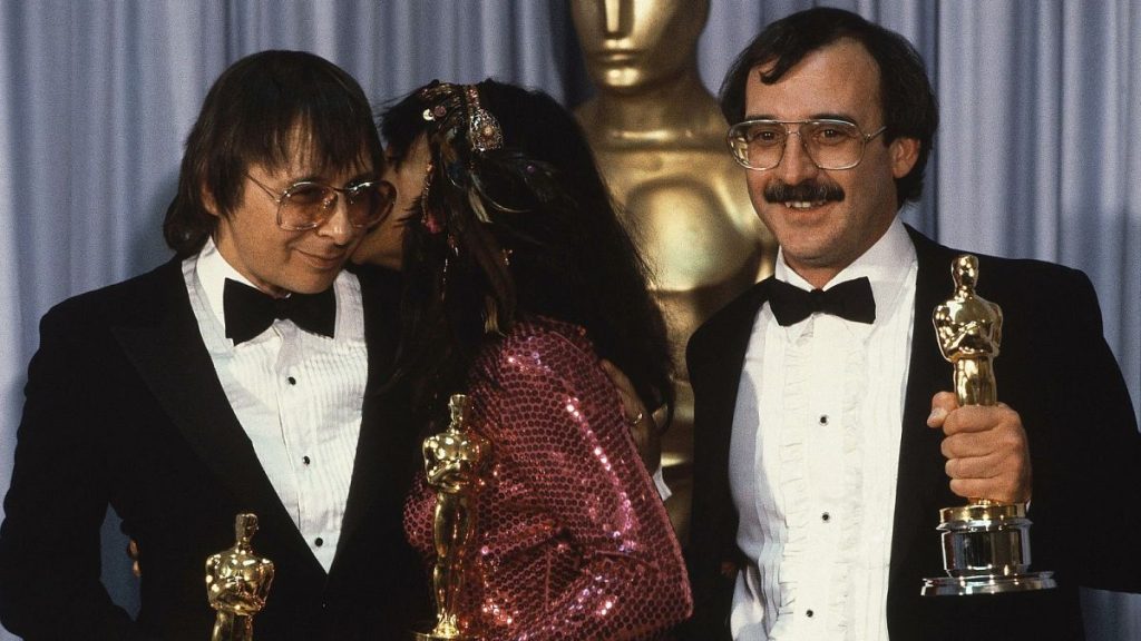 From L-R: Jack Nitzsche, Buffy Sainte Marie and Will Jennings pose after winning the Oscar for best original song “Up Where We Belong” at 55th Academy Awards, 1983