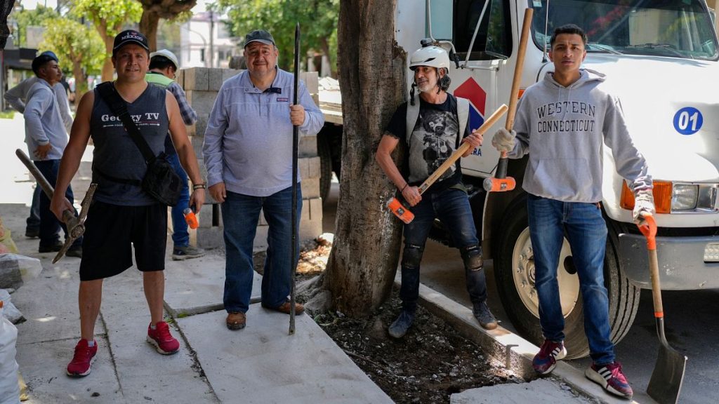 Arturo Hernandez, second from right, poses next to members of The Tree Army, a group that works to improve the urban forest in Mexico City, 26 August 2024.