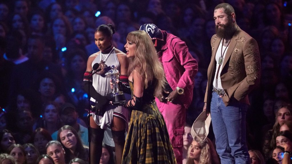 Taylor Swift, center, and Post Malone, far right, accept the award for best collaboration for