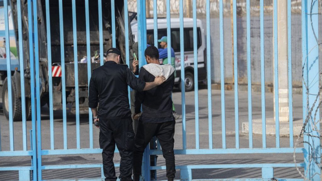 A member of the Moroccan security forces detains a man attempting to cross the border with the Spanish enclave of Ceuta, in Fnideq, Morocco, Monday, Sept. 16, 2024.