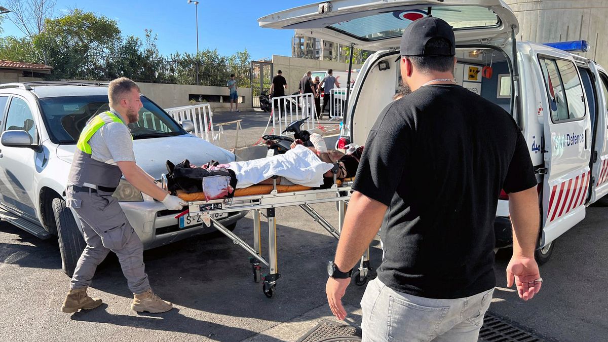 Civil Defence responders at al-Zahraa hospital in Beirut, Lebanon carry a wounded man whose handheld pager exploded.