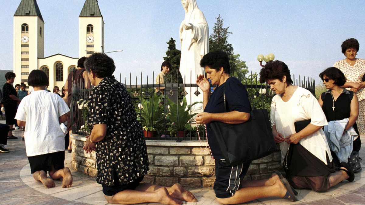 Roman Catholic women pray on  feast of the Assumption in Medjugorje, some 120 kilometers (75 miles) south of the Bosnian capital, Sarajevo, on Aug. 15 2000