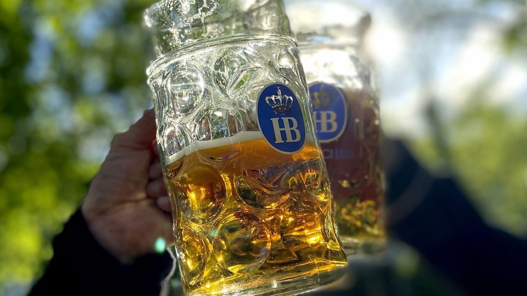 People toast with their beer mugs at the