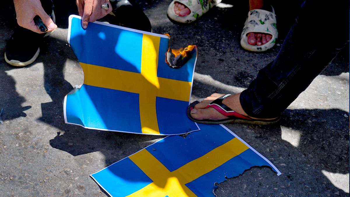 FILE: Hezbollah supporters trample representations of the Swedish flags during a rally denouncing the desecration of the Quran in Beirut, 21 July 2023