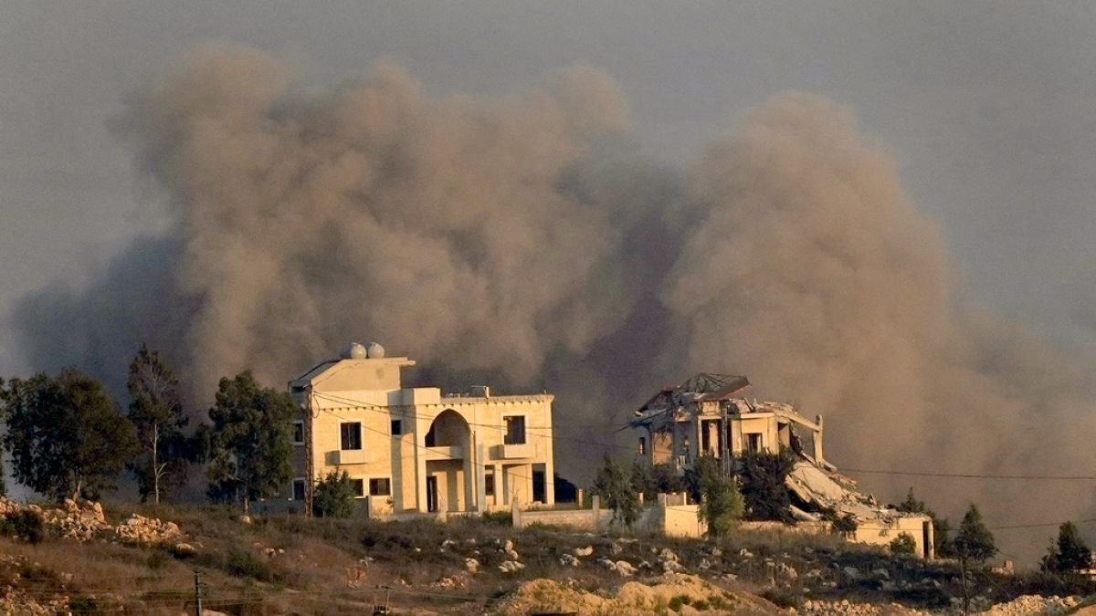 Smoke rises behind a destroyed house following an Israeli airstrike on Khiam village, as seen from Marjayoun town, south Lebanon, Tuesday, Sept. 24, 2024