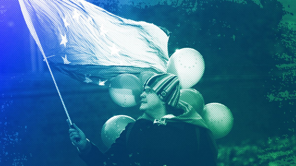 FILE: A man waves the European flag in front of the Houses of Parliament in London, May 2019