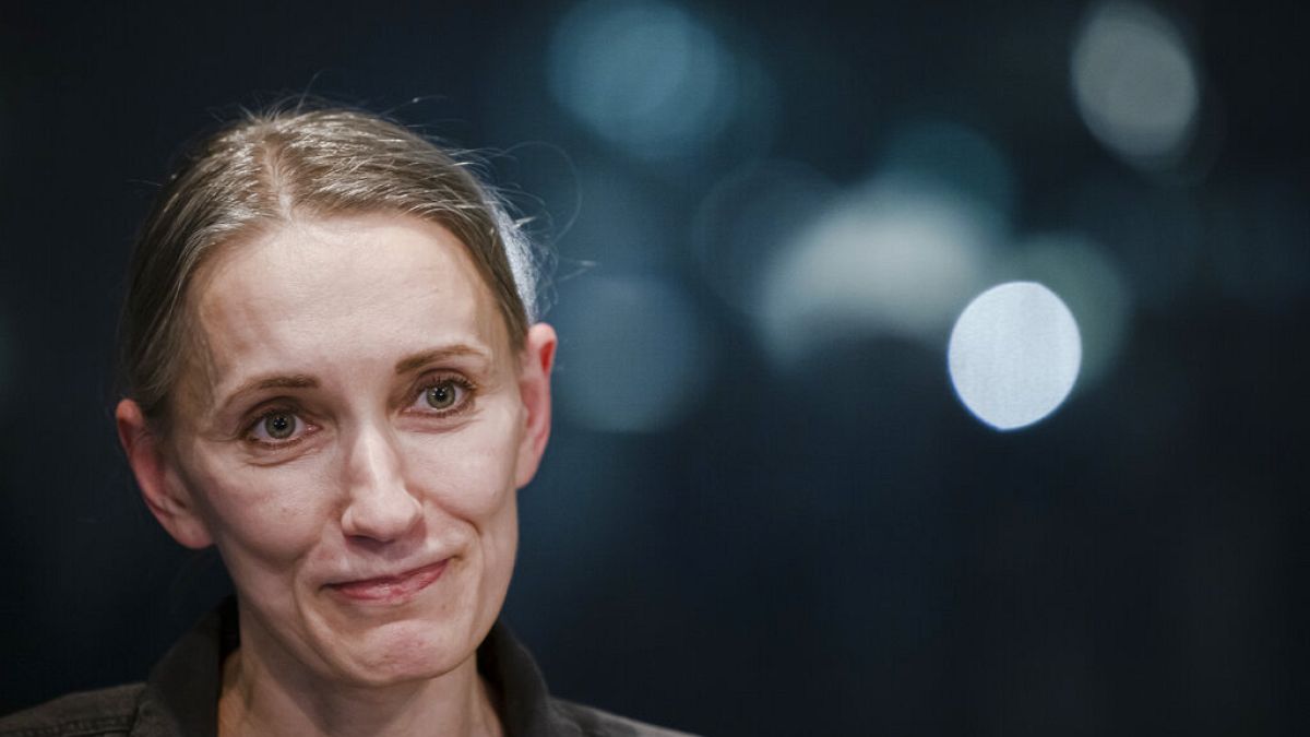 Natallia Hersche speaks to the media at the Zurich Airport, Switzerland, on Friday, Feb. 18, 2022.