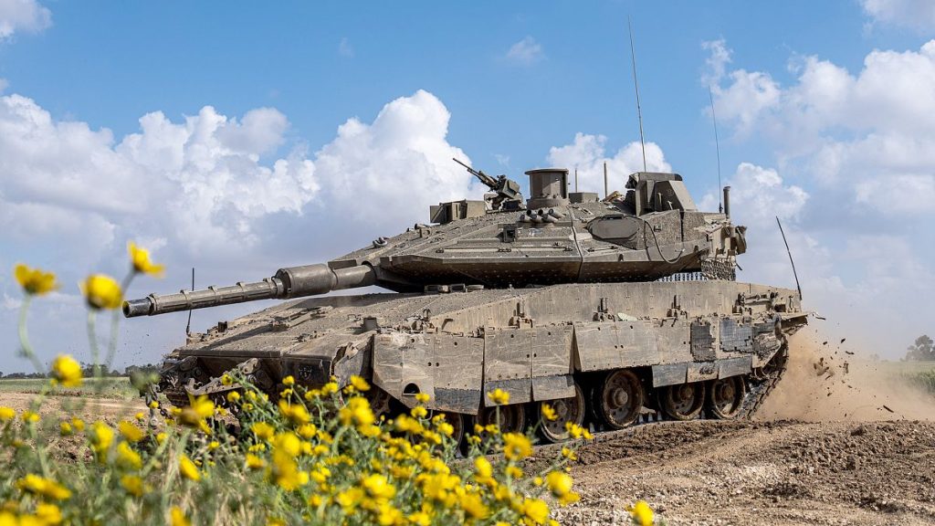 FILE: Israeli soldiers drive a tank on the border with Gaza Strip, in southern Israel, 19 March 2024