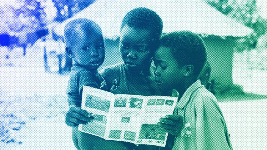 Children read a pamphlet about the dangers of landmines, in Moli village, Eastern Equatoria state, in South Sudan, May 2023