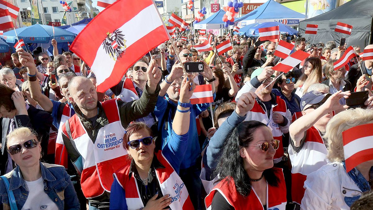 FILE: Supporters wave Austrian flags during the final election campaign event of the far-right Freedom Party (FPO) for the European elections in Vienna, 24 May 2019