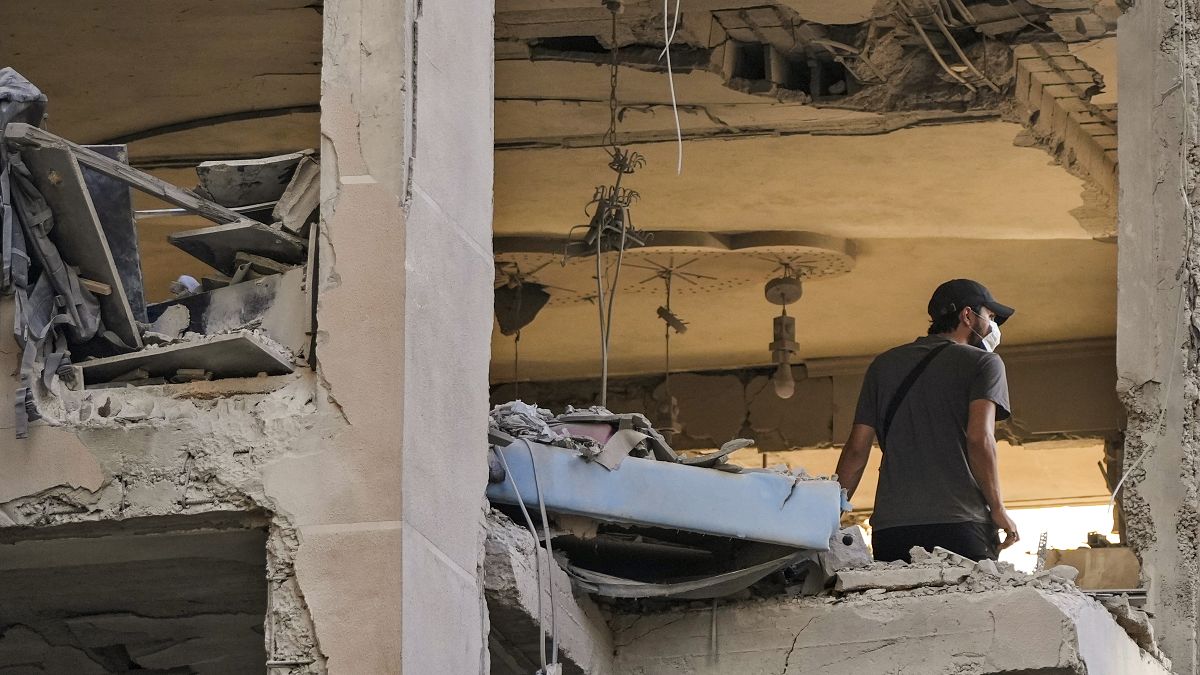 A resident checks an apartment that was hit by an Israeli airstrike in Beirut