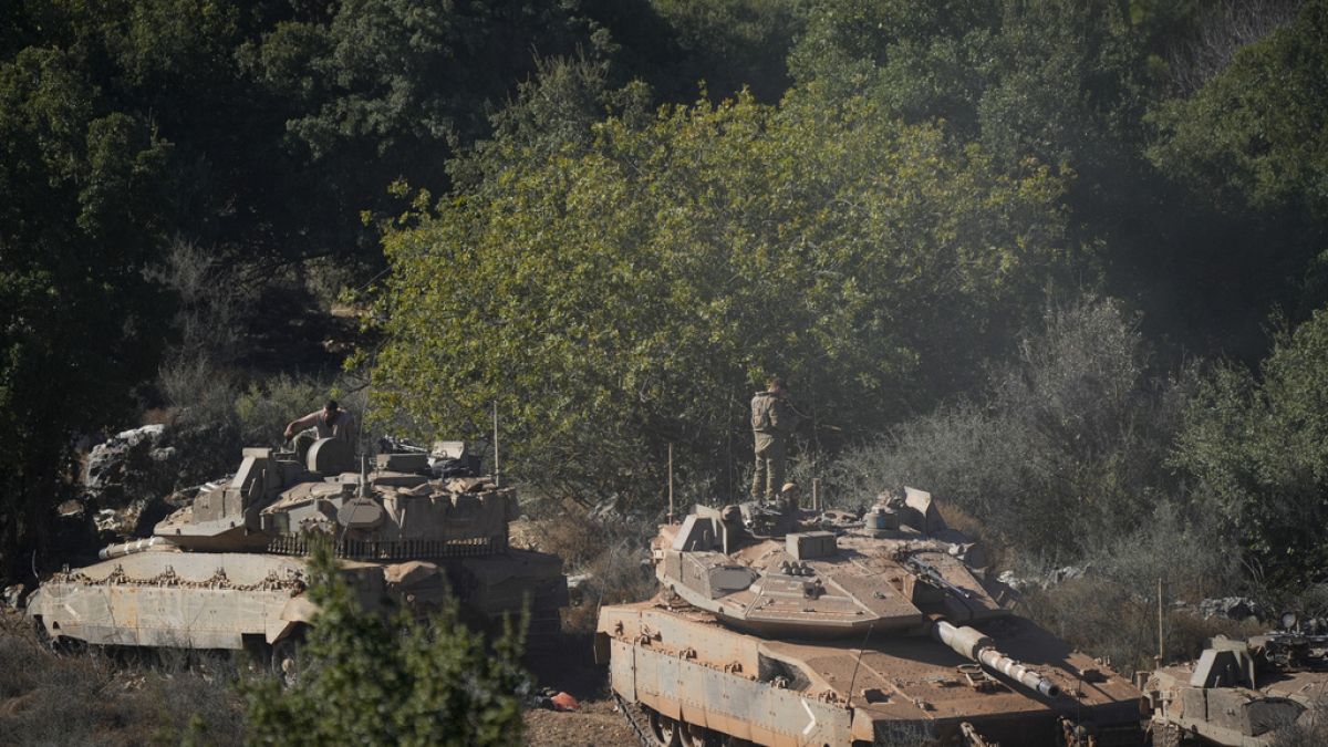 Israeli soldiers work on tanks in northern Israel on Friday, Sept. 27, 2024. (AP Photo/Baz Ratner)