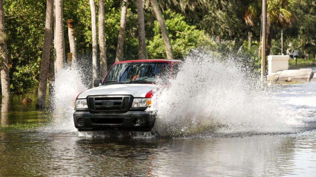 A truck drives through a flooded street around the Sunset Park neighborhood as Hurricane Helene makes its way toward the Florida panhandle on Thursday, Sept. 26, 2024, in Tamp