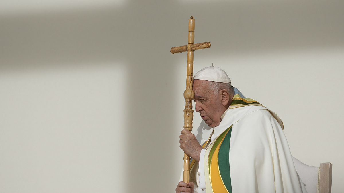 Pope Francis holds the pastoral staff as he presides over the Sunday mass at King Baudouin Stadium in Brussels, September 29, 2024