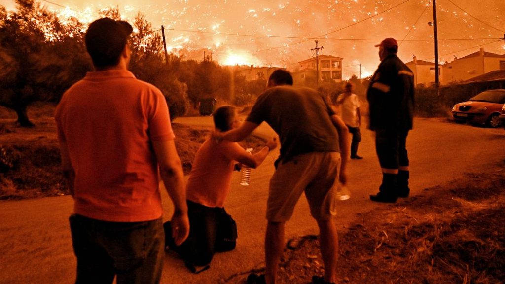 A resident reacts as a wildfire approaches the village of Ano Loutro as fanned by strong winds raged, 29 September 2024.