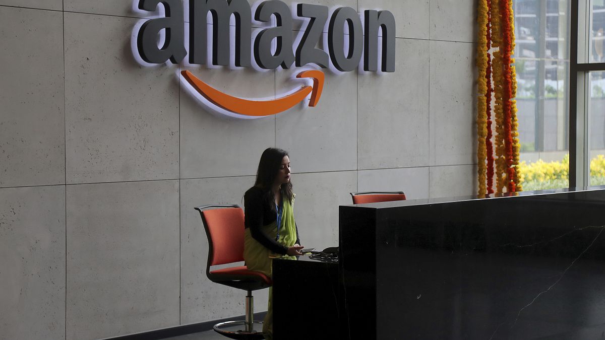 An Indian employee works at the reception desk of Amazon