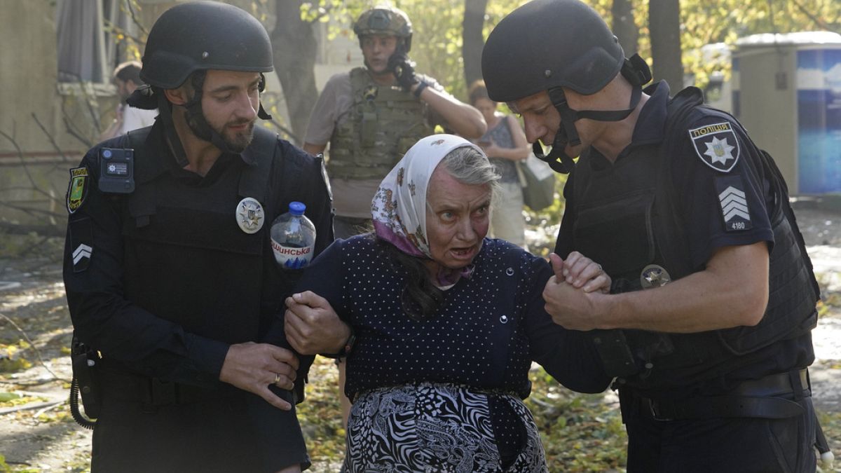 An elderly woman is assisted after a Russian aerial bomb struck a multi-story residential building in Kharkiv, Ukraine, Sunday Sept. 15, 2024.