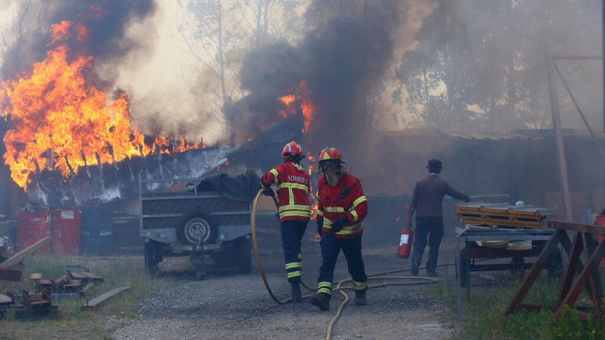 Firefighters work to control a fire in Sever do Vouga, a town in northern Portugal that has been surrounded by forest fires, Monday, Sept. 16, 2024.