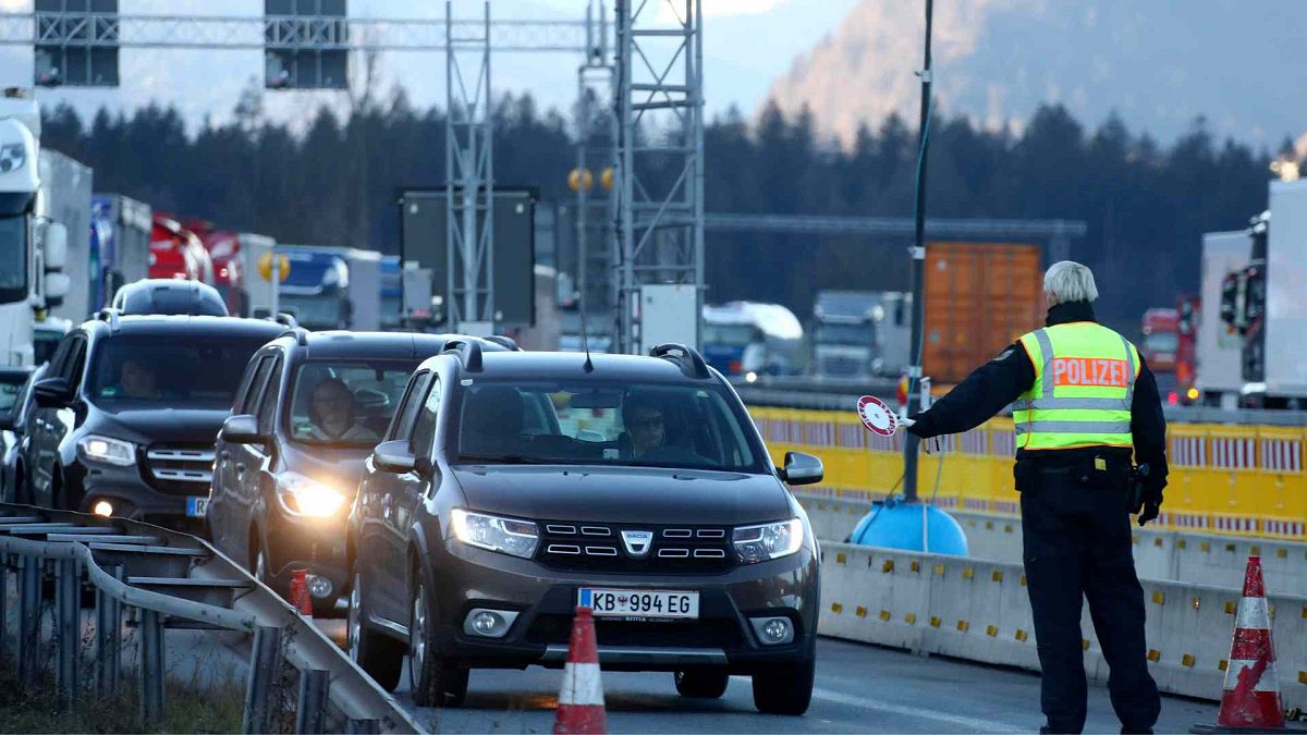 German federal police officers check cars at the Austrian-German border, 16 March 2020.