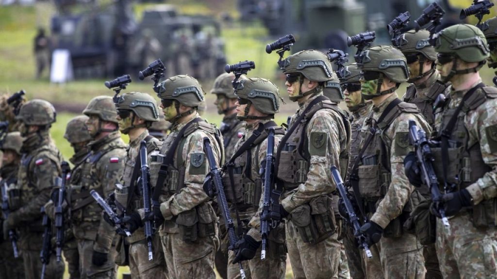 FILE - Lithuanian soldiers near the Polish border at the Dirmiskes village, in Lithuania on Friday, April 26, 2024.