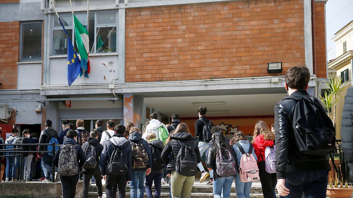 Pupils enter their high school in Rome.