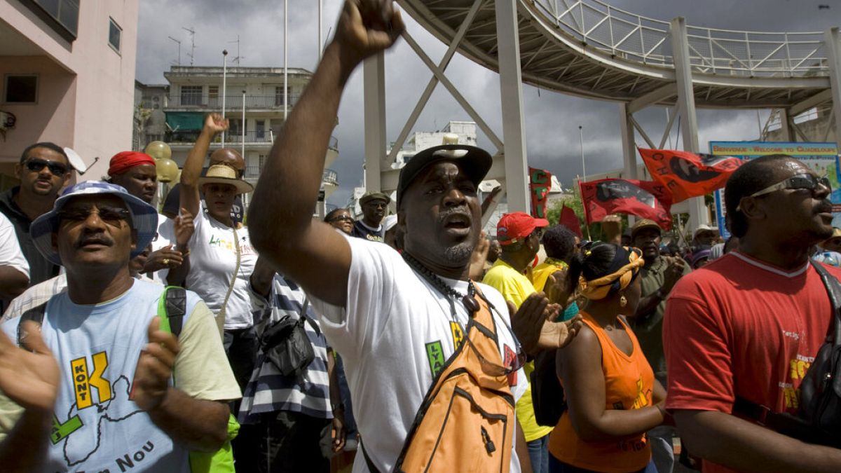 In this Feb. 23, 2009 file photo, labor union members shout slogans during a protest in Point-a-Pitre, French Caribbean island of Guadeloupe.