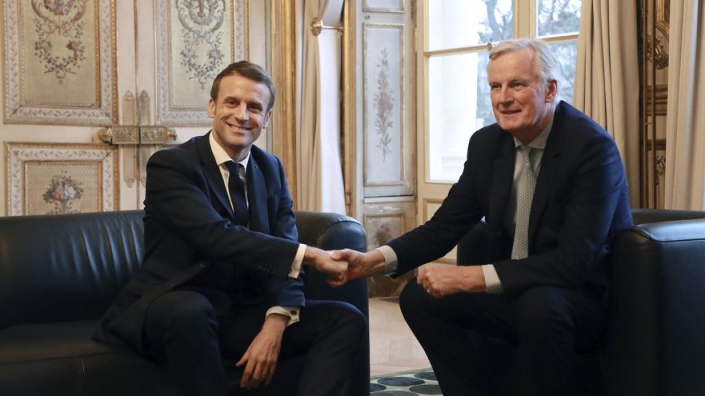 Emmanuel Macron, left, shakes hands with then-European Union chief Brexit negotiator Michel Barnier at the Elysee Palace in Paris, Friday, Jan. 31, 2020.