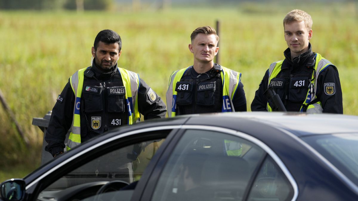 German police check the details of a French car near the border to Belgium in Aachen, Germany, Monday, Sept. 16, 2024.