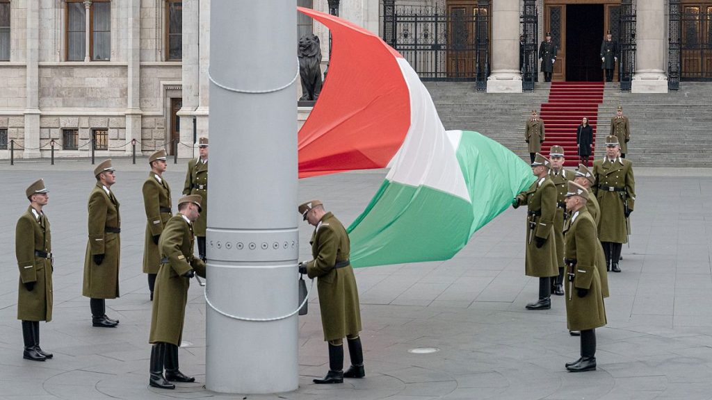 FILE Hungarian honour guards lower the national flag at half mast on the day of the national mourning of the 1956 revolution, 4 November 2022