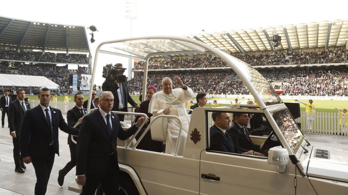 Pope Francis waves as he arrives to lead the holy mass , at the King Baudouin stadium in Brussels, Belgium, Sunday, Sept. 29, 2024