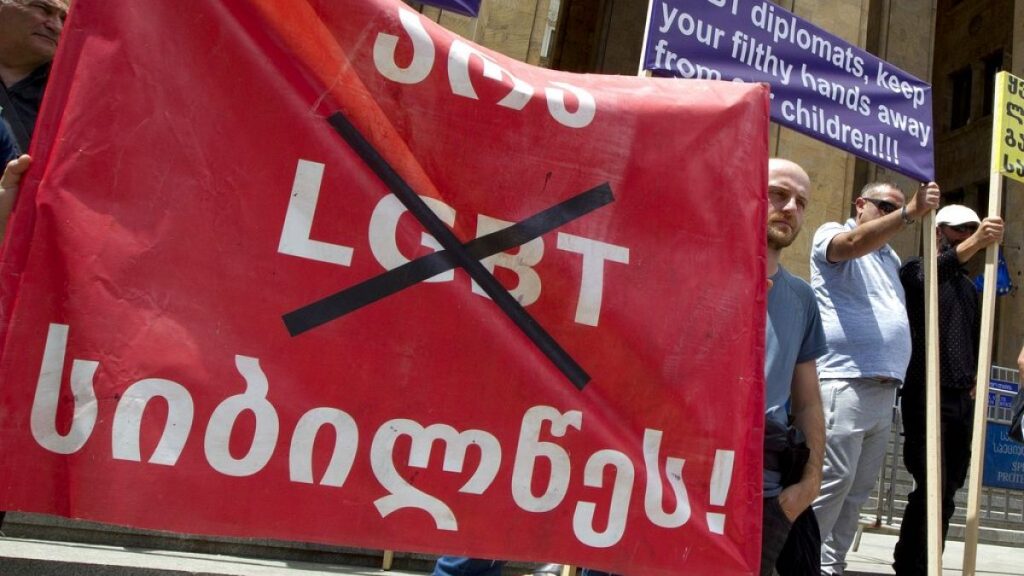 Georgian far right parties and their supporters hold a banner that reads: