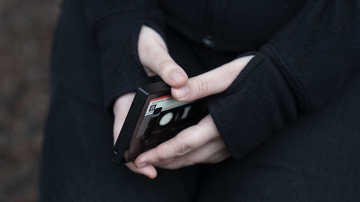 A teenage girl holds her smartphone.