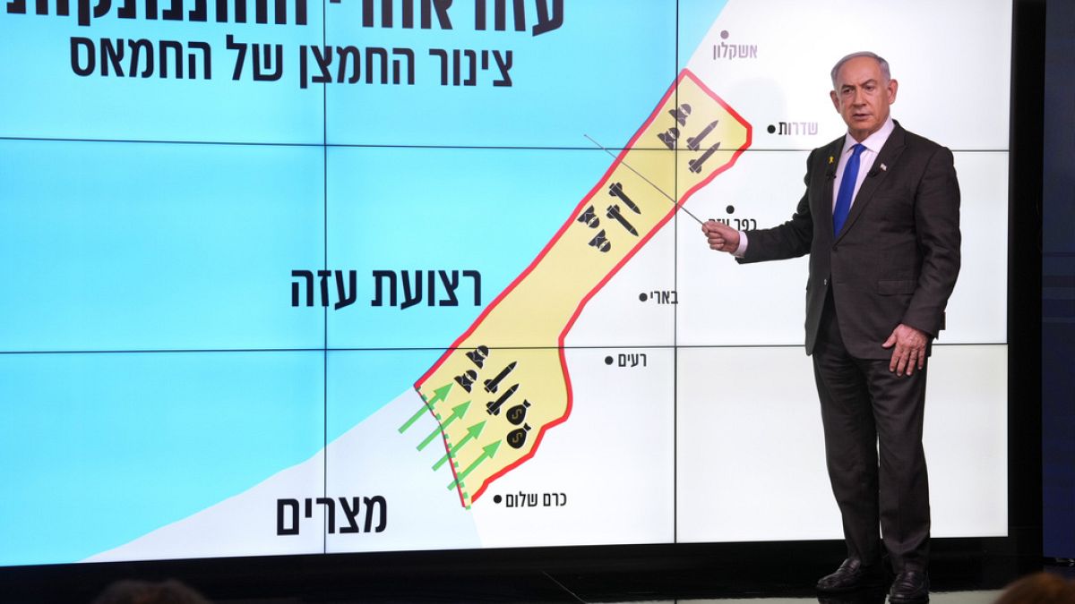 Israeli Prime Minister Benjamin Netanyahu stands before a map of the Gaza Strip, explaining how Hamas has imported arms into the territory since Israel