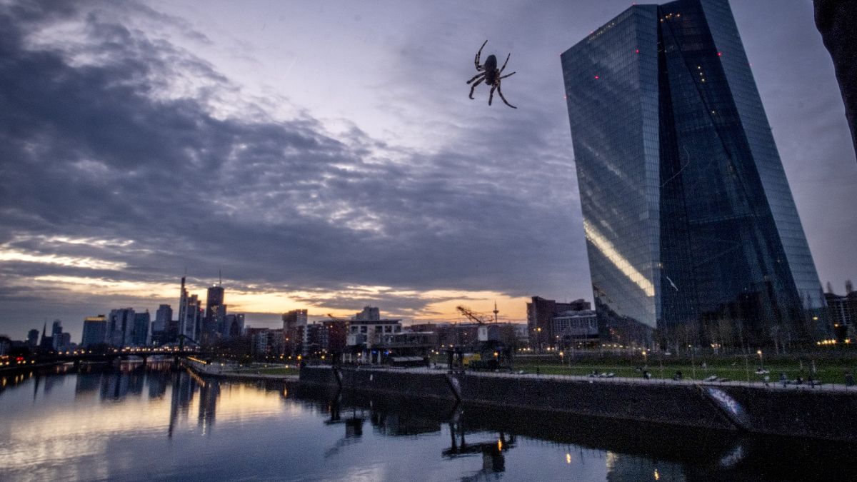 Hanging by a thread, a spider in the railing of a bridge next to the ECB at the river Main in Frankfurt, Germany