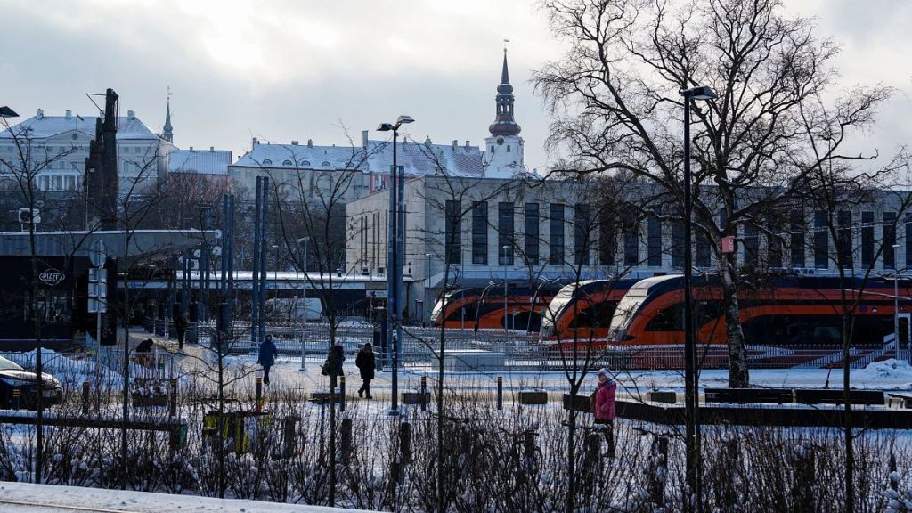 People walk at Baltic train station, with the Stenbock House, left, and St Mary