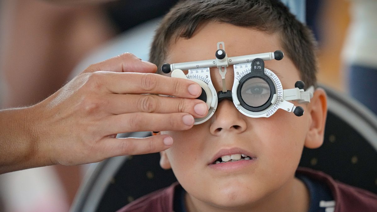 A boy undergoes an eyesight examination performed by volunteer ophthalmologists, in Nucsoara, Romania.