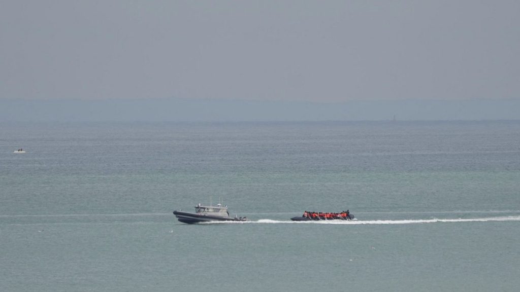 A boat thought to be with migrants is escorted by a vessel from the French Gendarmerie Nationale off the Wimereux beach, France