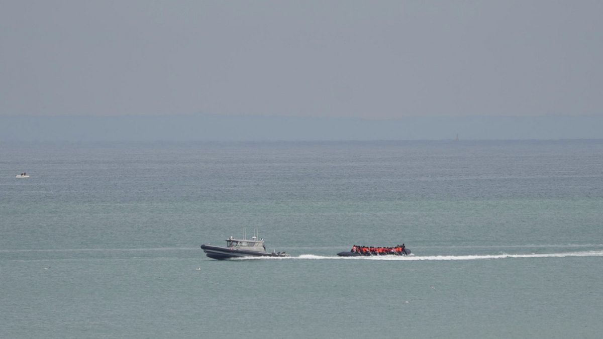 A boat thought to be with migrants is escorted by a vessel from the French Gendarmerie Nationale off the Wimereux beach, France