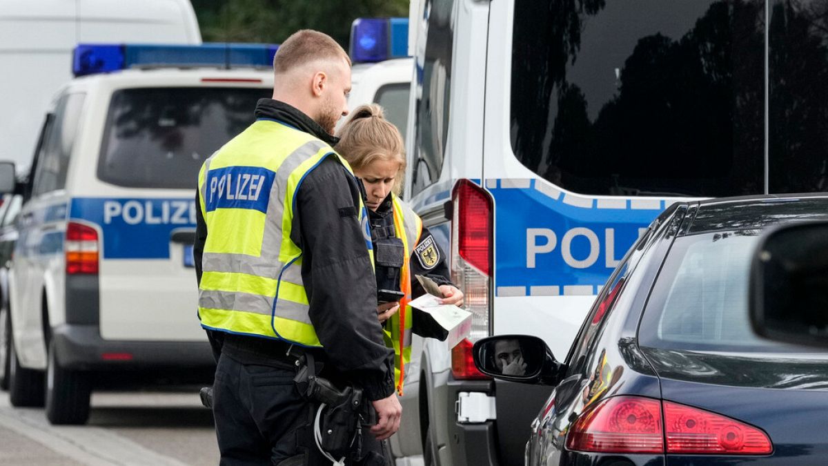 German police check the details of a French car near the border to Belgium in Aachen, Germany, Monday, Sept. 16, 2024.