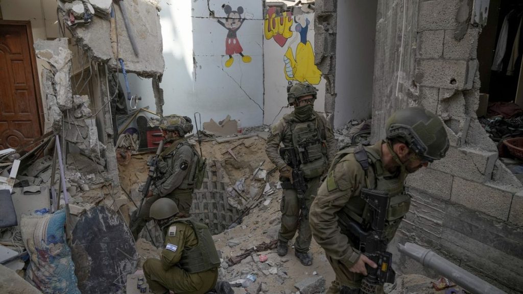 Israeli soldiers stand at the entrance of a tunnel where the military says six Israeli hostages were recently killed by Hamas militants, in the southern Gaza Strip on Sep 13.