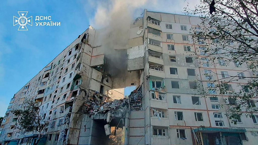 Smoke, dust and debris can be seen after after a Russian attack that hit a residential building in Kharkiv, Ukraine.